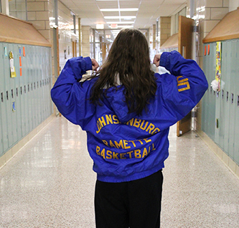 Female basketball player showing back of her jacket